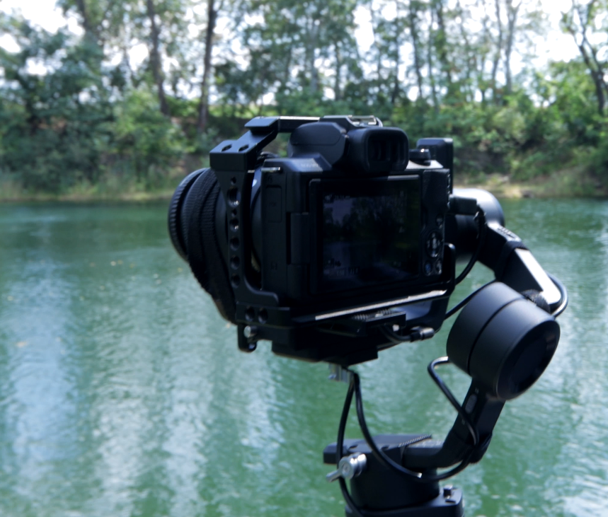 A camera suspended on a line in a dark room with LED walls in the background
